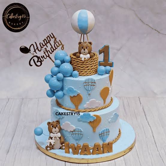This is a personalized teddy bear theme first birthday cake by Cakestry15 with a "Sky-High Teddy Celebration" design.